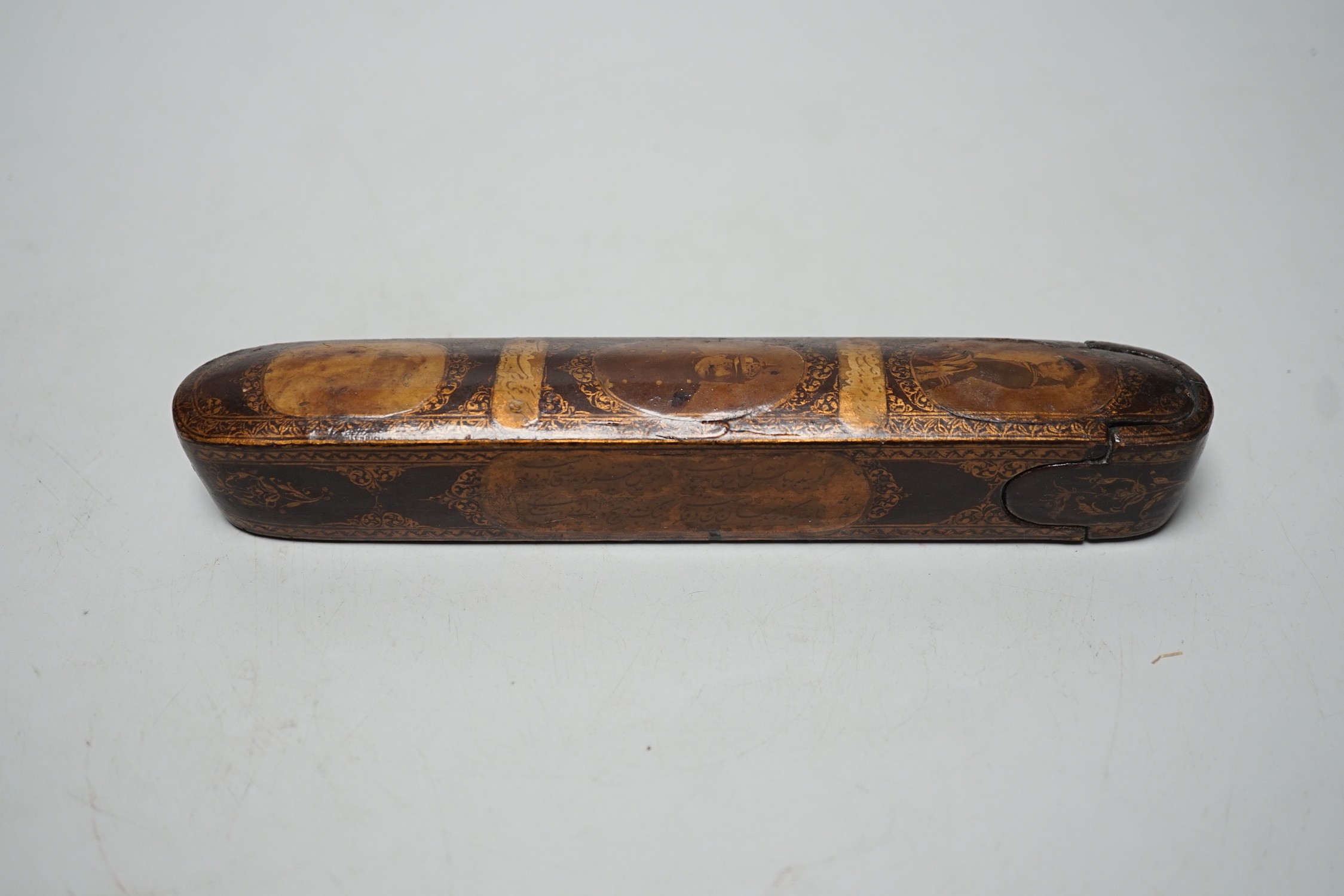A 19th century Persian lacquered pen tray with later applied German portraits, total length 20cm